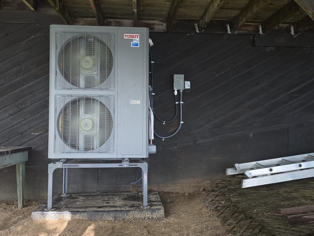 Cold-climate heat pump installed on a stand at an Ottawa property
